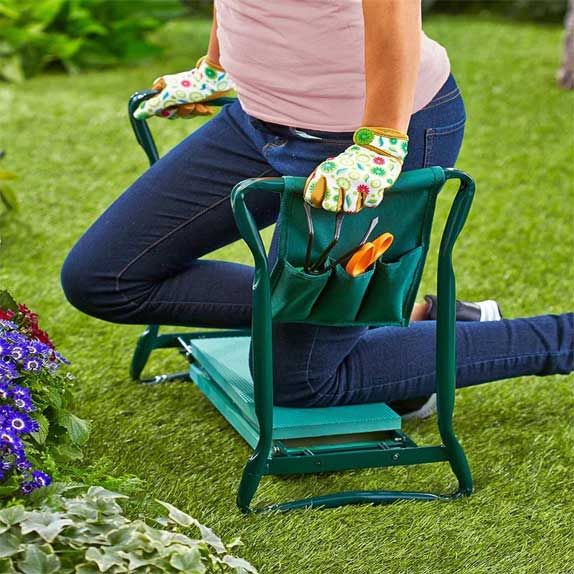 Gripping the padded arm-rails while kneeling